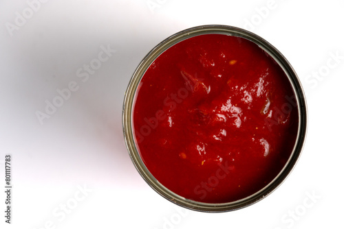 A tin of Italian chopped tomatoes in rich juice on a white background. Top view.