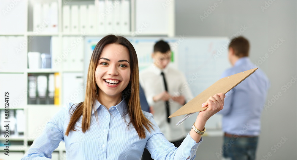 Portrait of happy woman working with smart colleagues in big modern building and participating in intense brainstorming process. Company meeting concept Portrait of happy woman working with smart colleagues in big modern building and participating in intense brainstorming process. Company meeting concept