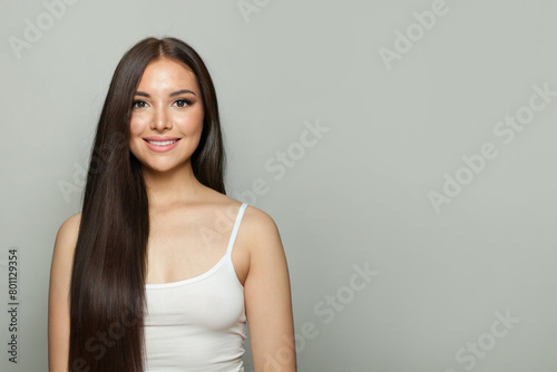 Brunette model woman with natural make-up, healthy skin and long hair. Female beauty, cosmetology and skincare concept