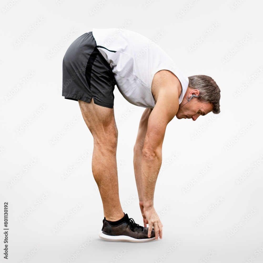 Man stretching in forward fold before exercise Man stretching in forward fold before exercise