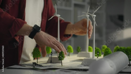 A Caucasian man who is actively involved in research into green energy using models of windmills. His work aims to create sustainable urban environments based on the use of alternative energy sources photo