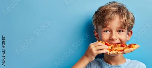 Adorable child enjoying tasty pizza on soft toned background with space for text