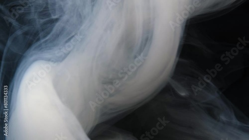 Swirling smoke creates captivating patterns under subtle lighting. (ID: 801134333)