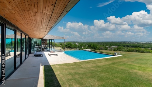 Texas Tranquility: A Contemporary Retreat with a Sprawling Pool and Panoramic Views" "Luxe Living in the Lone Star State: Modern Oasis with Cascading Windows and Lush Surroundings"