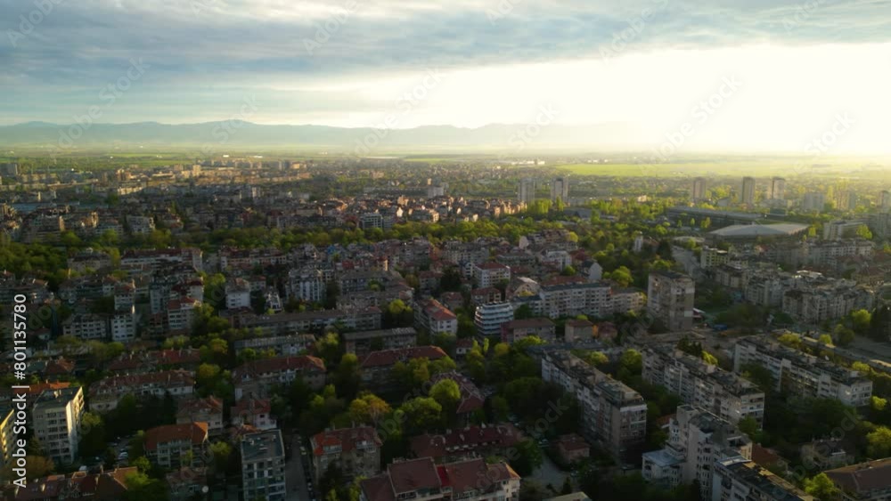 Aerial drone shot of the old town in Sofia. The national stadium, eagle's bridge and Perlovska river as seen from above during sunset in spring. High angle footage green park and stadium in Bulgaria
Aerial drone shot of the old town in Sofia. The national stadium, eagle's bridge and Perlovska river as seen from above during sunset in spring. High angle footage green park and stadium in Bulgaria