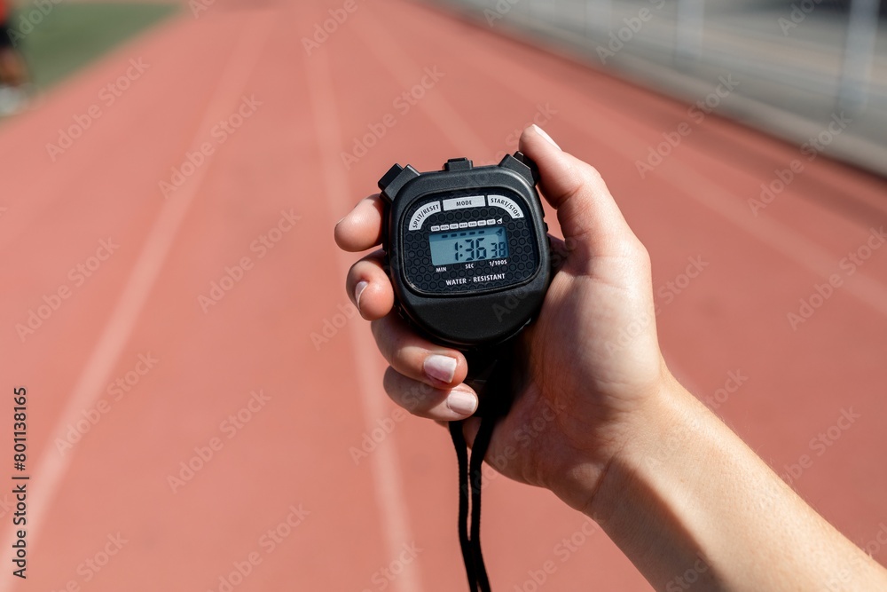Fototapeta premium Hand holding stopwatch