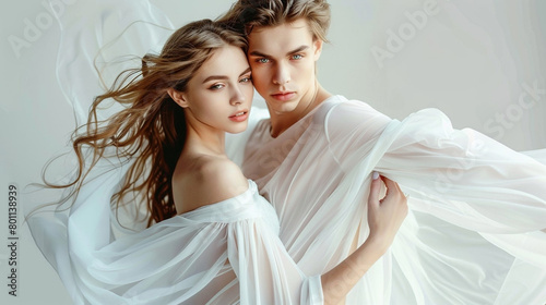 Young beautiful couple in love dancing on a white background