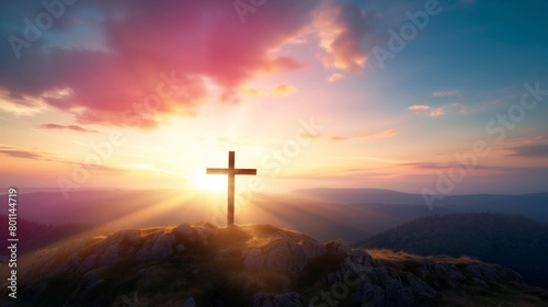 The crucifix symbol of Jesus on the mountain sunset sky background.