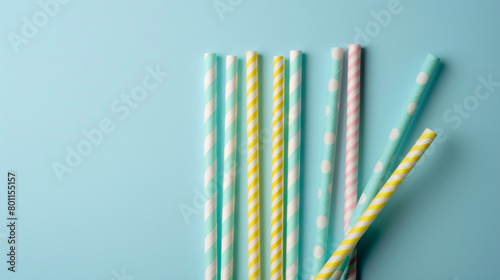 Different paper drinking straws on blue background