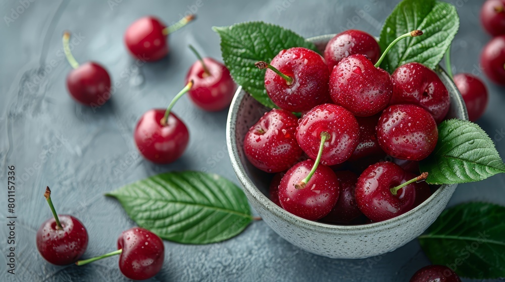 A bowl of cherries on the table is adorned with leaves and water droplets delicately resting atop each juicy fruit A bowl of cherries on the table is adorned with leaves and water droplets delicately resting atop each juicy fruit