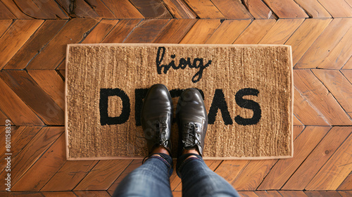 Doormats with words and shoes in hall top view