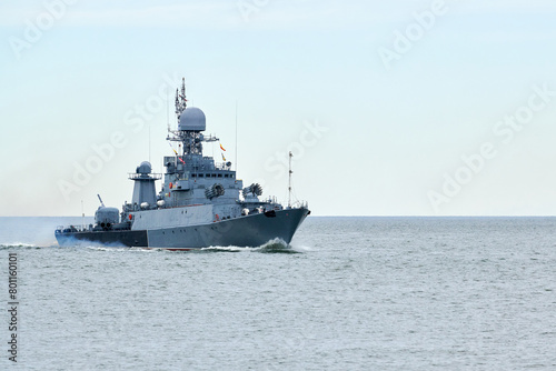 Russian warship armed with armament sails into sea toward military target to attack and destroy enemy, military ship performing strategic maneuver, Russian sea power deployment for tactical advantage © TRAVELARIUM
