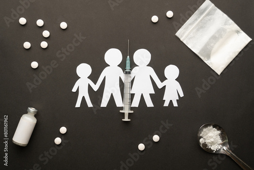 Drug addiction affects the family. Paper cut of family destroyed by drugs on dark background. International Day against Drug Abuse.