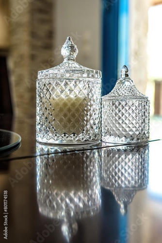 Close-up view of two exquisite glass vases, each serving as a sophisticated candle holder. Used as centerpieces for weddings, events, or home decor. Atmosphere with their beauty and charm