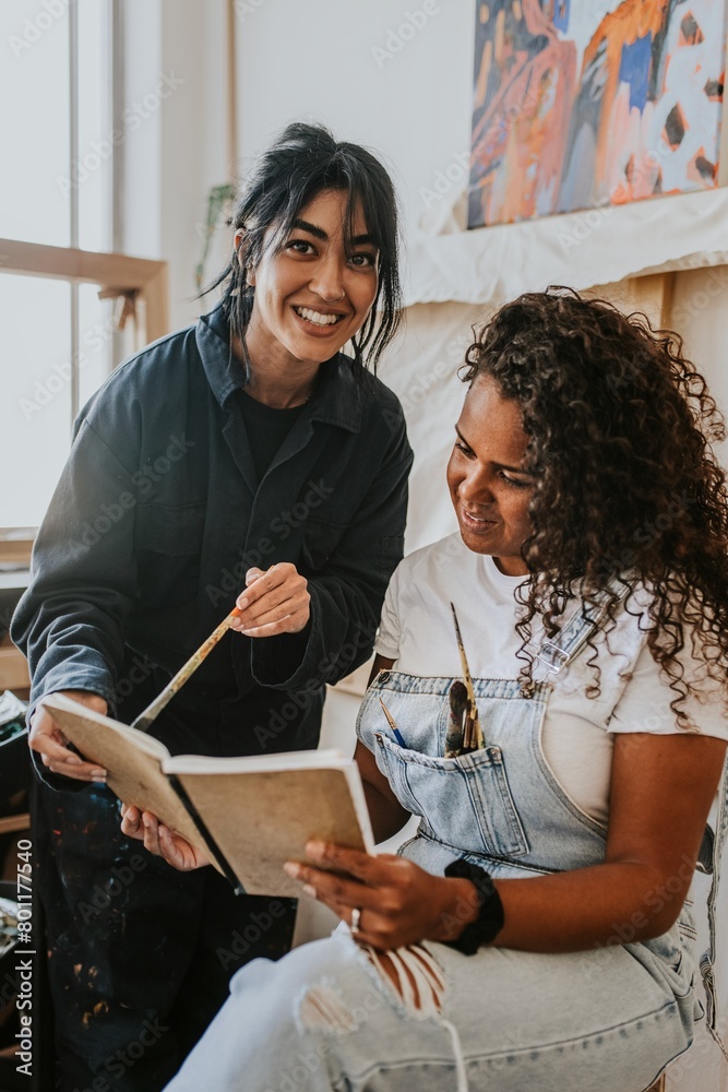 Woman artist reading and brainstorming together Woman artist reading and brainstorming together
