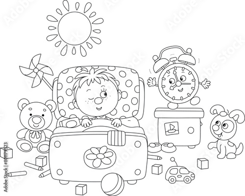 Little boy awaking up in his pretty small bed among toys after merry rings of a funny alarm clock in a nursery room on a sunny morning, black and white vector cartoon illustration