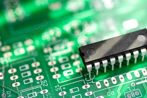 DIP package IC microchip on a green printed circuit board. © Kuzmick