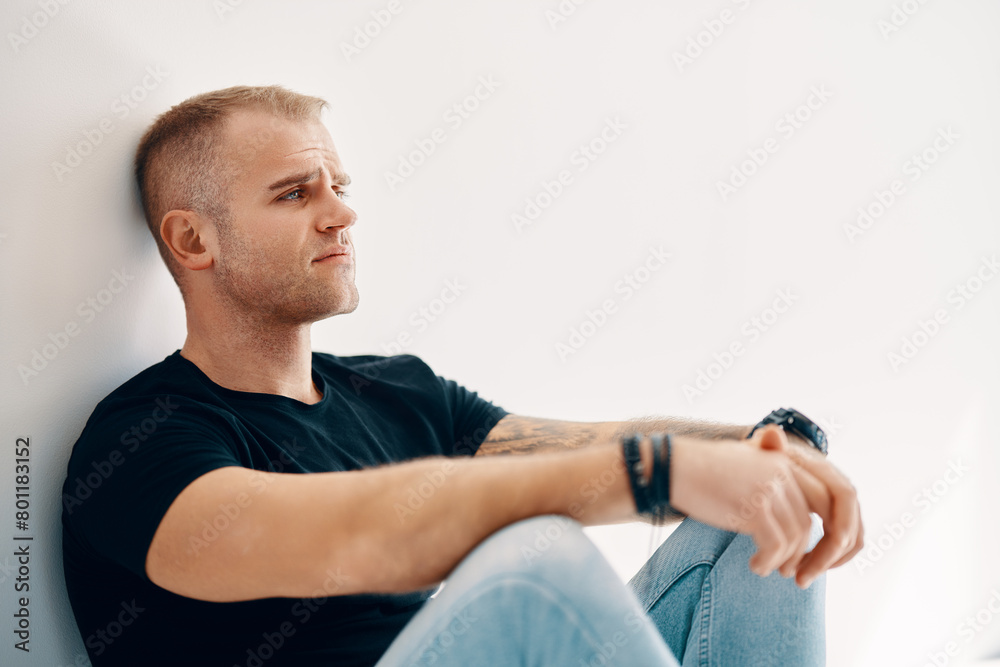 Tired man sitting on the floor Tired man sitting on the floor