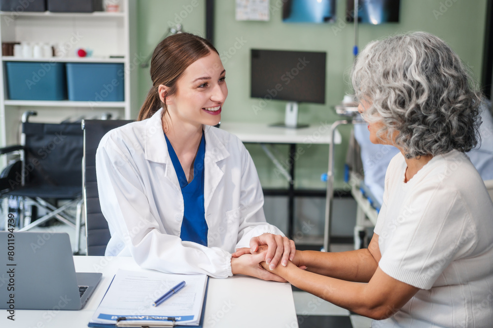 Obraz premium Monthly health check-ups and counseling sessions are provided to an elderly Asian woman by a Caucasian female caregiver, offering support, advice, and motivation.