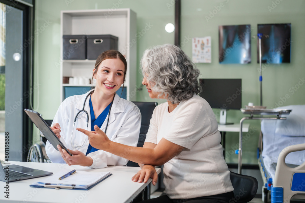 Obraz premium Monthly health check-ups and counseling sessions are provided to an elderly Asian woman by a Caucasian female caregiver, offering support, advice, and motivation.
