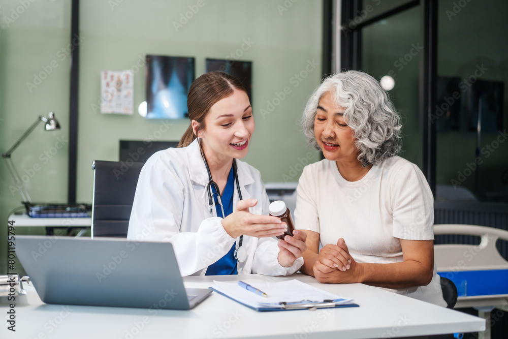 Monthly health check-ups and counseling sessions are provided to an elderly Asian woman by a Caucasian female caregiver, offering support, advice, and motivation.