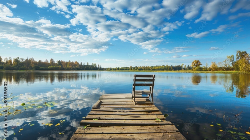 Landscape with a long wooden pier with chairs for fishing and relaxing enjoying the lake view Landscape with a long wooden pier with chairs for fishing and relaxing enjoying the lake view