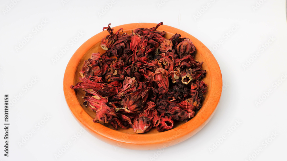 Dried roselle flowers on a wooden plate Dried roselle flowers on a wooden plate