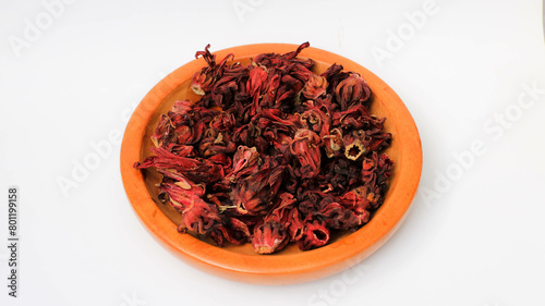 Dried roselle flowers on a wooden plate