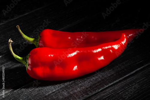 sweet pepper on black wood background © bergamont