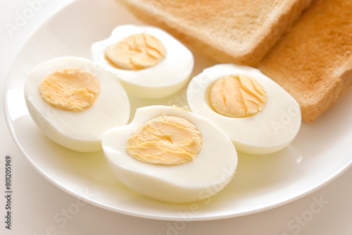 Boiled eggs with two slices of toast on a plate. 