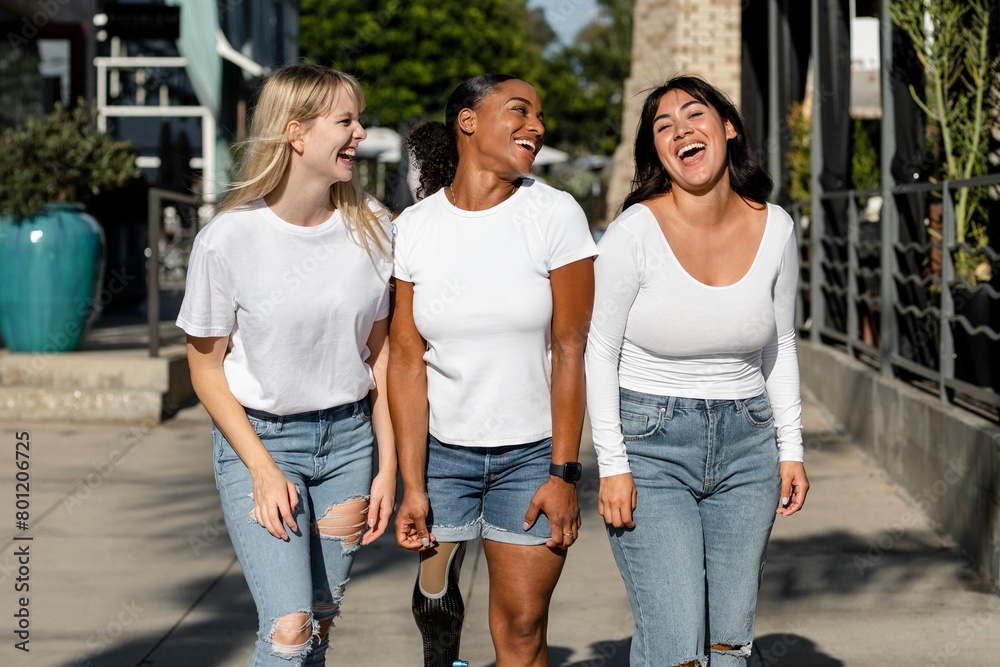 Fototapeta premium Three mixed race women, wearing plain white tshirts, community of inclusion & equality