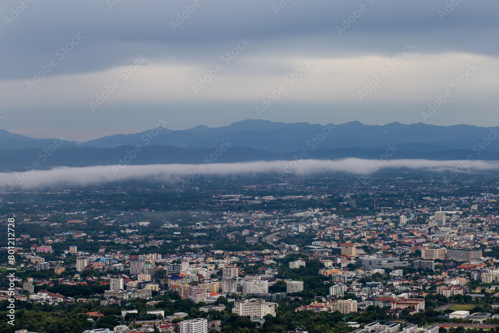 High-angle view of the city with mist passing through. Many buildings in Chiang Mai, Thailand