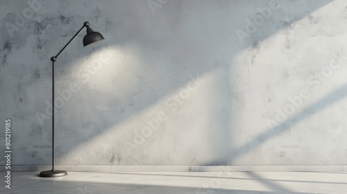 Light gray wall with a solitary industrial metal lamp photo