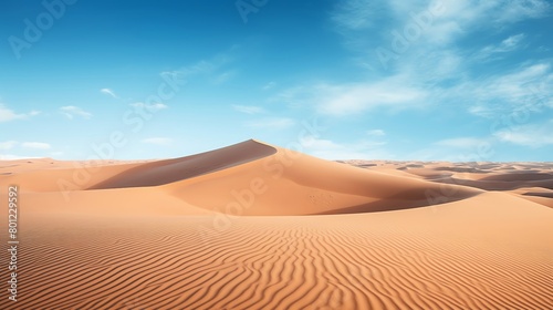 Dramatic landscape photograph of the Sahara Desert showcasing windsculpted dunes under a clear blue sky ideal for nature and travel publications © Jenjira