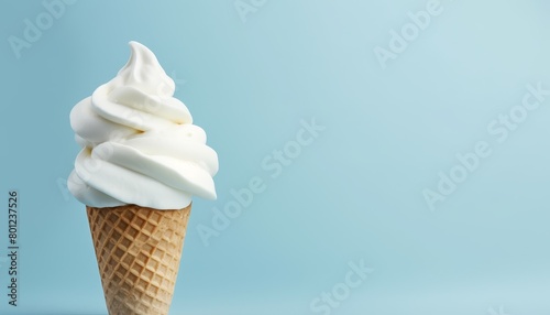 A delicious vanilla soft serve ice cream cone on a blue background.