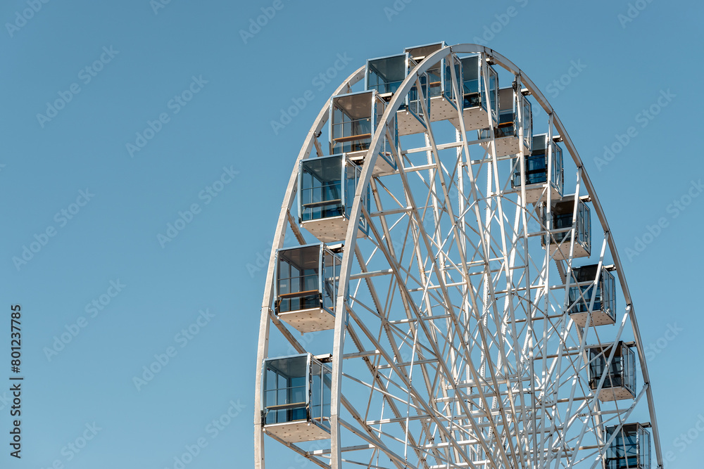 View of modern ferris wheel on background of blue sky in Kyiv city. View of modern ferris wheel on background of blue sky in Kyiv city.