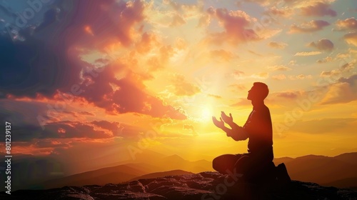 Silhouette of a person kneeling with his arms open and looking at the sky at sunset