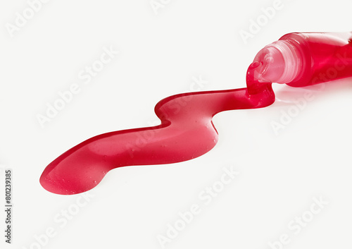 Red Lip gloss spills out of the tube
