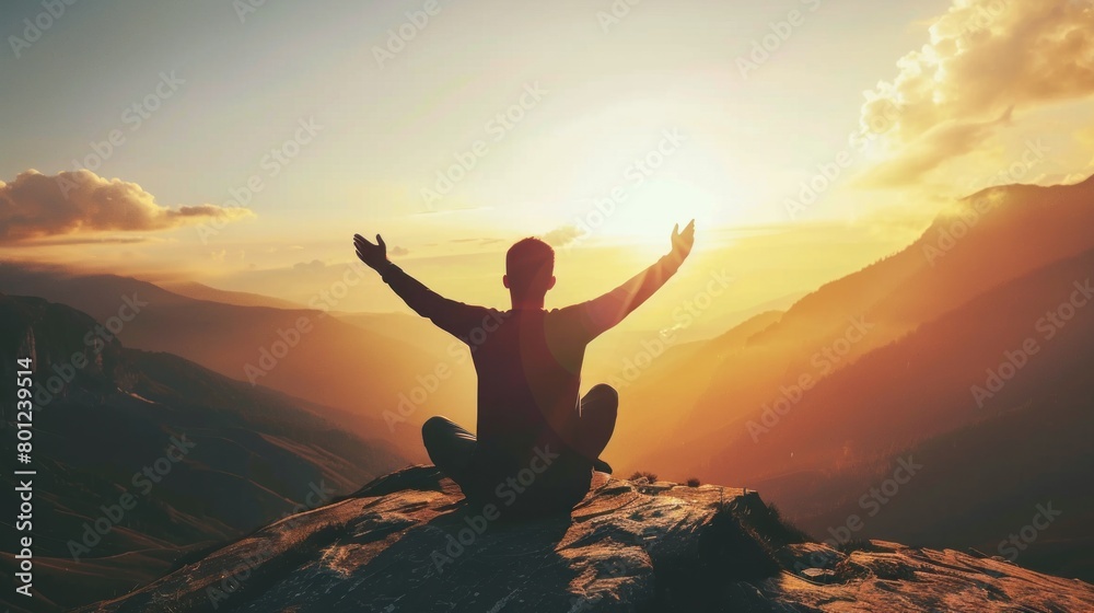 Silhouette of a person kneeling with his arms open and looking at the sky at sunset