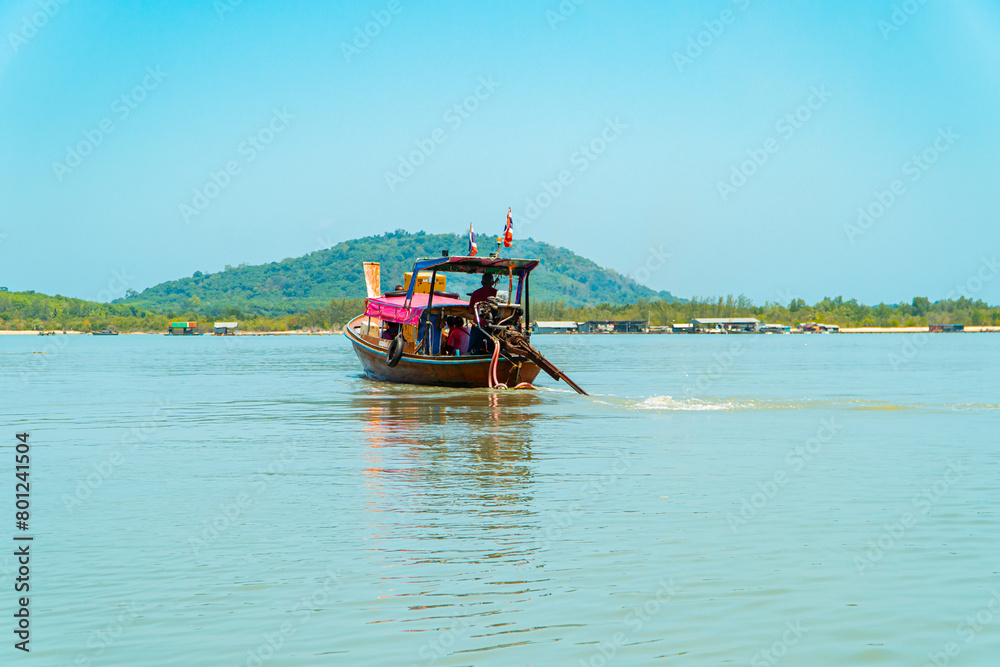 Traditional Thai boats dock and pass around Phi-phi Island, Thailand. Traditional boats made of wood and decorated are the transportation of choice for tourists Traditional Thai boats dock and pass around Phi-phi Island, Thailand. Traditional boats made of wood and decorated are the transportation of choice for tourists
