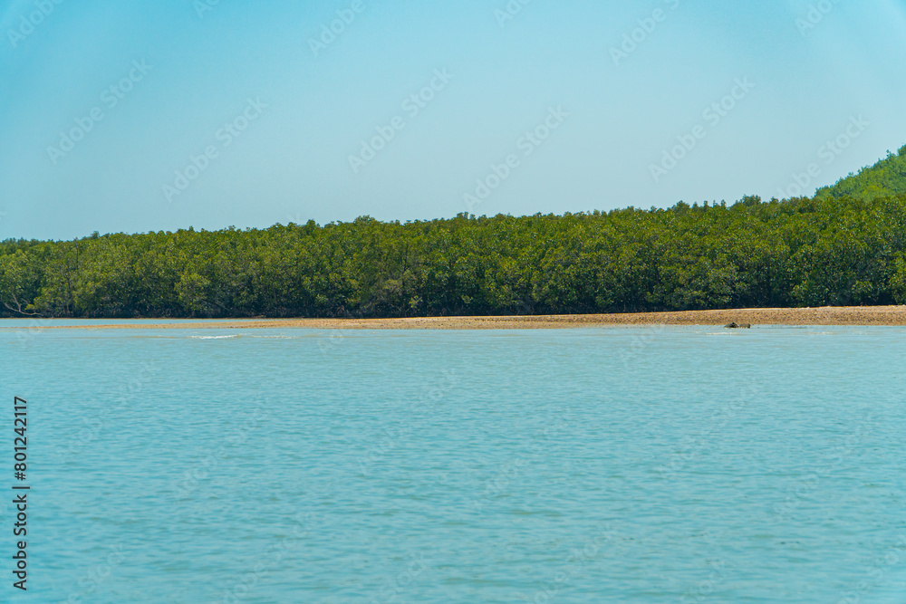 Panorama of blue sea with calm water in Phuket, Thailand. Wide sea with a background of land and hills.