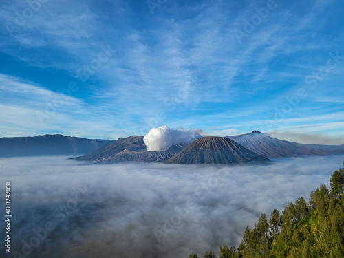 The clear sky is beautiful and blue with Mount Bromo still emitting volcanic smoke side by side with Mount Batok. The Sea of Sand plains began to appear because the fog began to disappear slowly