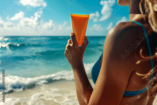 sunscreen. a girl on the beach holds sunscreen or lotion in her hands against the background of the ocean. Sun protection. Ultraviolet protection. vacation planning.