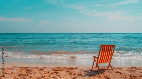 Serene beach view with a vibrant red and white striped chair inviting relaxation and escape, under a clear blue sky © leymart