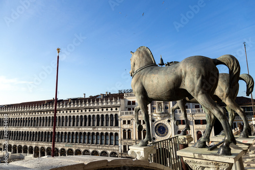 View of the Horses of Saint Mark in St Mark's Square on a beautiful sunny day. The Procuratie Vecchie and the Clock Tower in the background; Venice; Italy