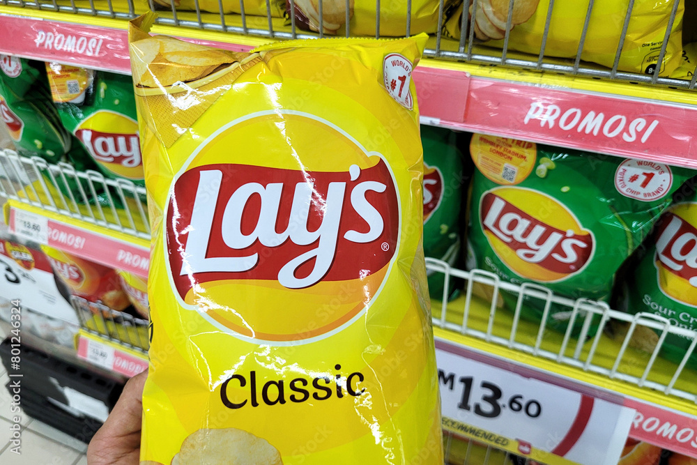 Lays Sampling In Store PENANG, MALAYSIA - 30 APR 2024: Close up a customer hand holding a Lays ...