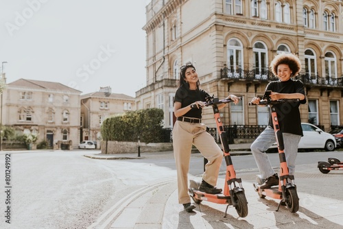 Friends on electric scooters, city sightseeing eco-friendly style