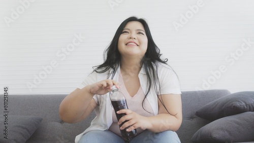 chubby woman drinking soft drink cola 