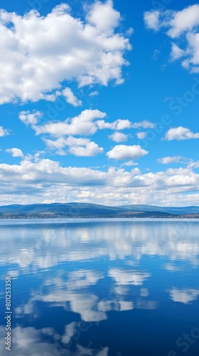 Blue sky and white clouds reflecting on the calm lake