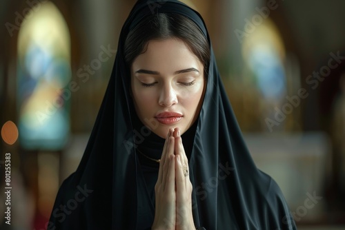 Caucasian nun in black habit devoutly praying inside the serene church sanctuary photo